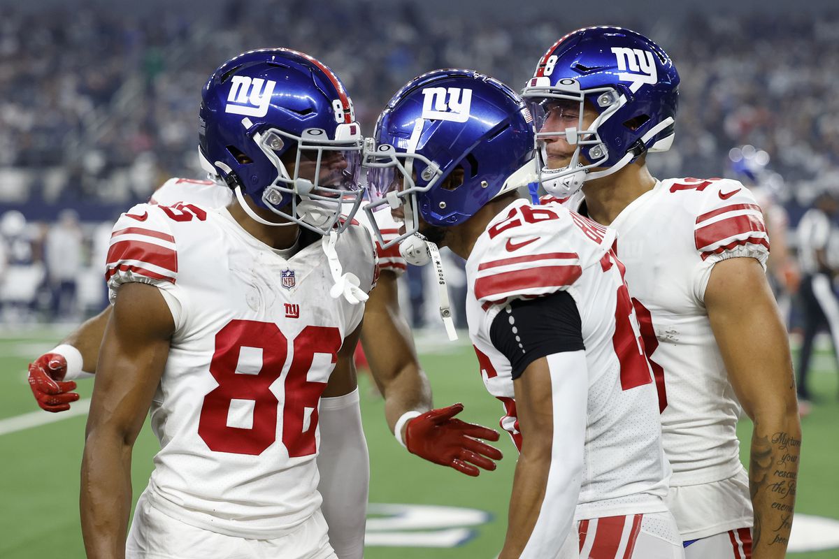 Darius Slayton #86 and Saquon Barkley #26 of the New York Giants celebrate a touchdown during the first half in the game against the Dallas Cowboys at AT&amp;T Stadium on November 24, 2022 in Arlington, Texas.