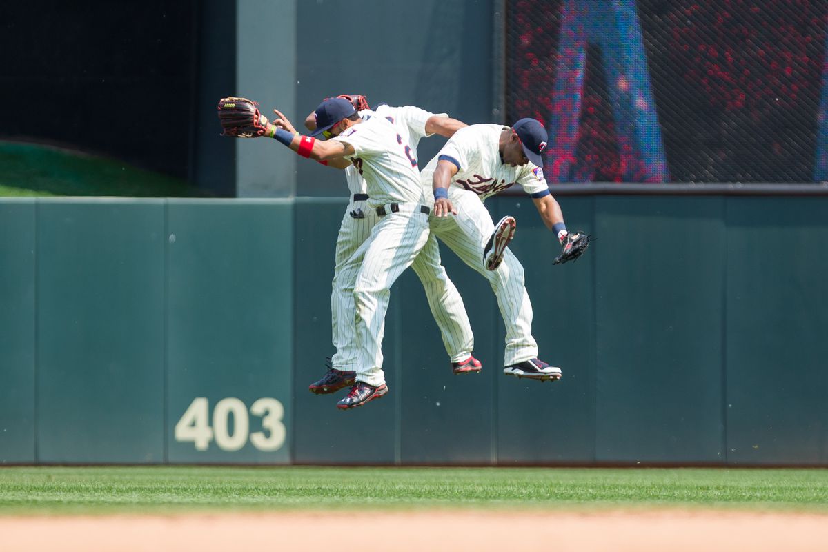 The Twins outfield celebrates a victory against the Red Sox