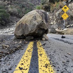 A large boulder sits in the middle of Bella Vista Drive in Montecito, Calif., following the rain storm, Tuesday, Jan. 9, 2018. (AP Photo/Michael Owen Baker)