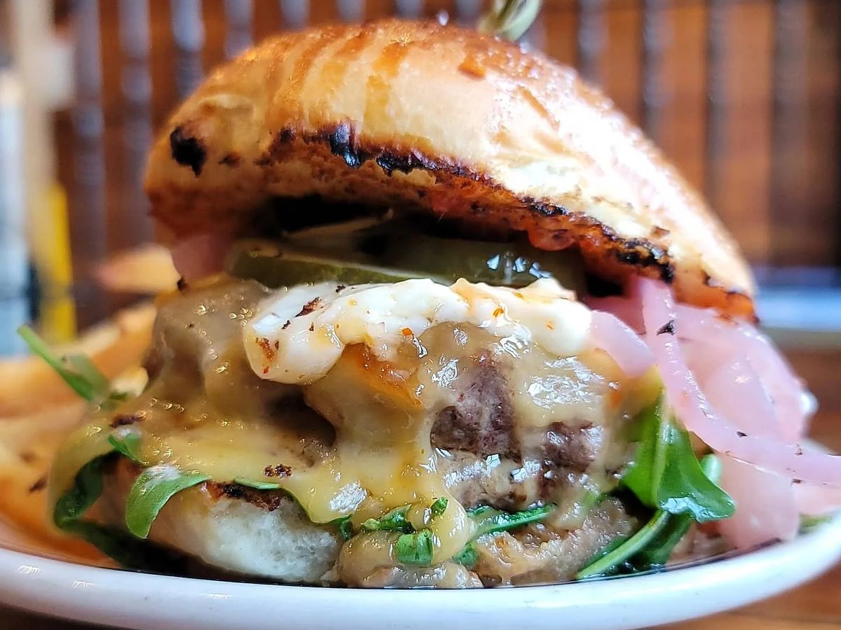 a cheesy, grilled onion-topped hamburger from Duke’s Grocery