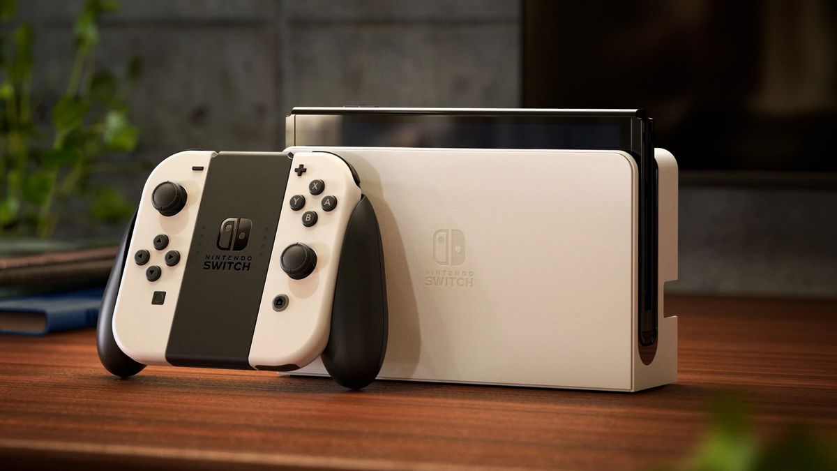 A photo of the Nintendo Switch (OLED model) in white on a wooden table