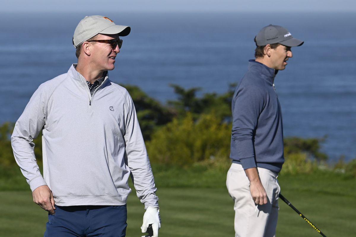 Peyton Manning (left) and Eli Manning (right) on the fourth hole during the first round of the AT&amp;amp;T Pebble Beach Pro-Am golf tournament at Spyglass Hill Golf Course.