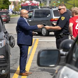 Salt Lake police detective Greg Wilking gathers information after responding to a car accident at 900 South and West Temple in Salt Lake City on Tuesday, May 7, 2019.