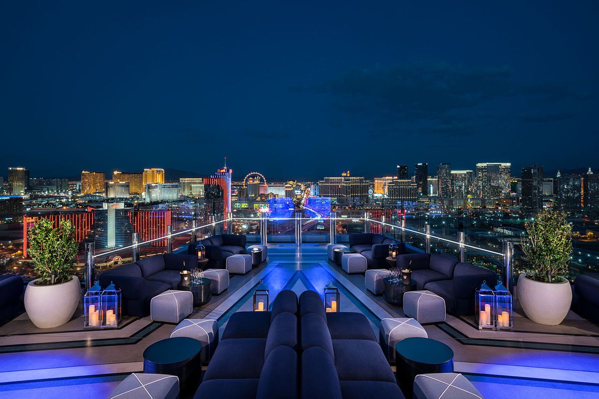 An outdoor lounge overlooks the Strip at night.