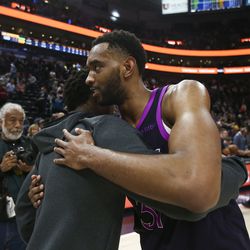 Utah Jazz guard Donovan Mitchell (45) hugs Minnesota Timberwolves forward Keita Bates-Diop (31) after the game at Vivint Smart Home Arena in Salt Lake City on Thursday, March 14, 2019.