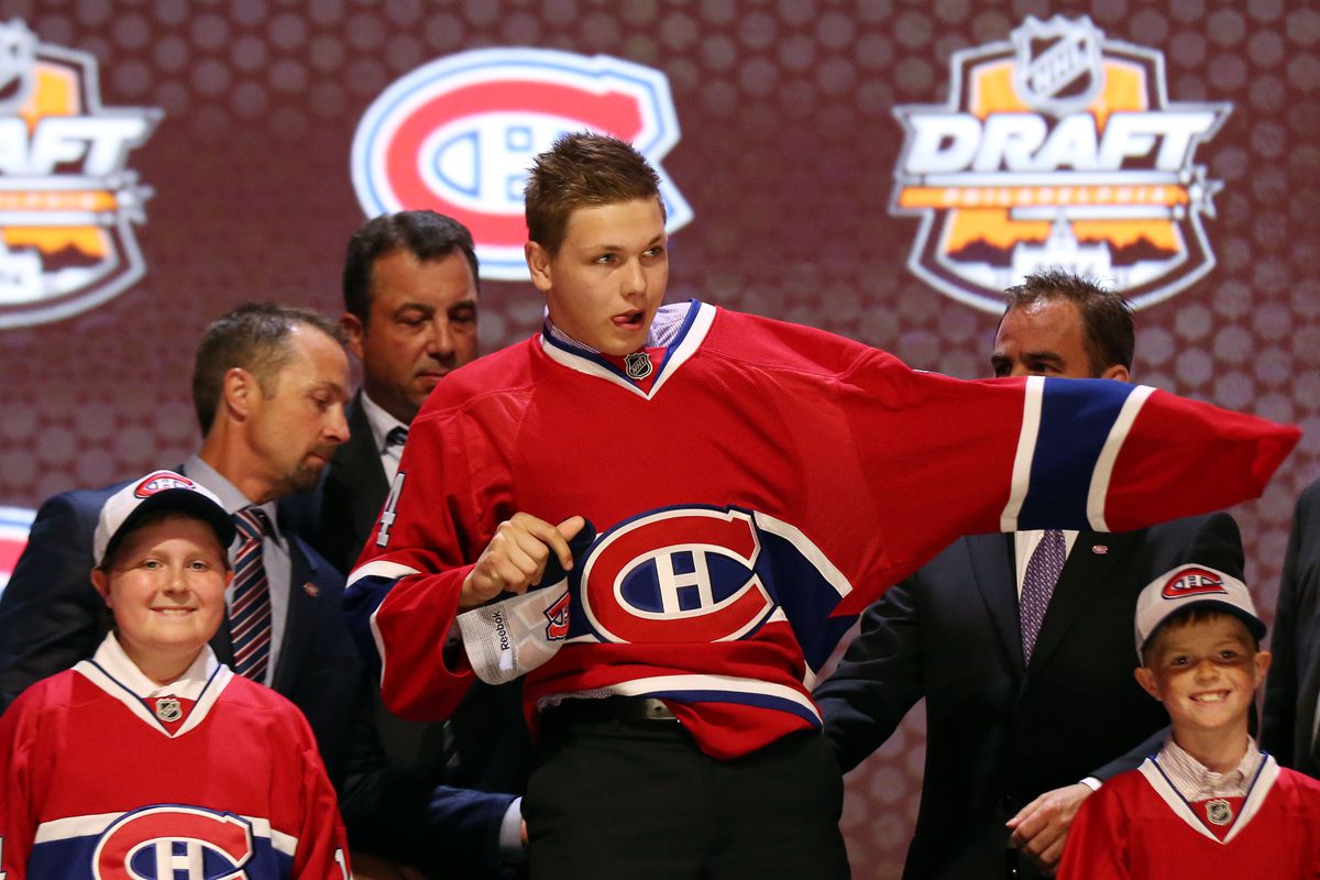 Jun 27, 2014; Philadelphia, PA, USA; Nikita Scherbak puts on a team sweater after being selected as the number twenty-six overall pick to the Montreal Canadiens