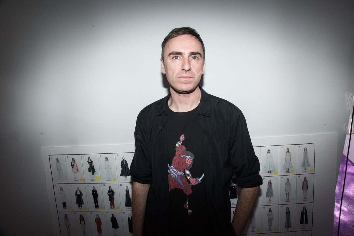 Raf Simons stands in front of the runway chart backstage at Christian Dior's fall 2015 couture show.