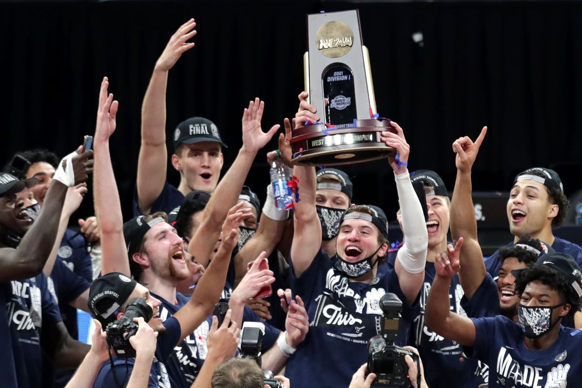 Gonzaga players celebrate at center court with their trophy after defeating USC during the Elite Eight round of the 2021 NCAA Tournament on Tuesday, March 30, 2021, at Lucas Oil Stadium in Indianapolis, Ind.&nbsp;
