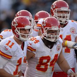 Kansas City Chiefs quarterback Alex Smith (11) and tight end Sean McGrath (84) celebrate after scoring a touchdown in the third quarter against the Oakland Raiders at O.co Coliseum. The Chiefs won 56-31. 