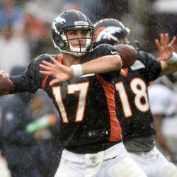 Broncos QBs Brock Osweiler and Peyton Manning throw during a rainy Summer Scrimmage at Sports Authority Field at Mile High