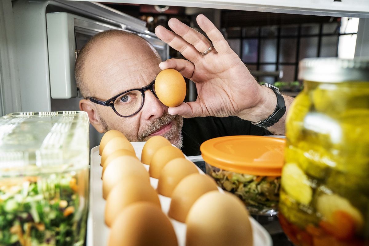 Alton Brown, as seen from inside a well-stocked refrigerator on “Good Eats: The Return,” holds an egg in front of one eye.