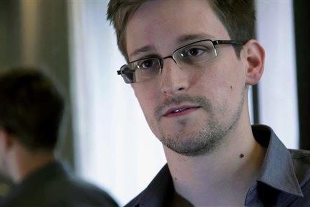 FILE - This June 9, 2013 photo provided by The Guardian newspaper in London shows Edward Snowden, who worked as a contract employee at the U.S. National Security Agency, in Hong Kong. The Guardian newspaper says that the British eavesdropping agency GCHQ 