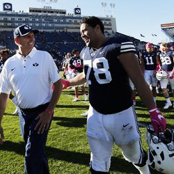 Offensive coordinator and quarterbacks coach Ty Detmer talks with Brigham Young Cougars offensive lineman Tuni Kanuch following NCAA football in Provo on Saturday, Oct. 28, 2017.