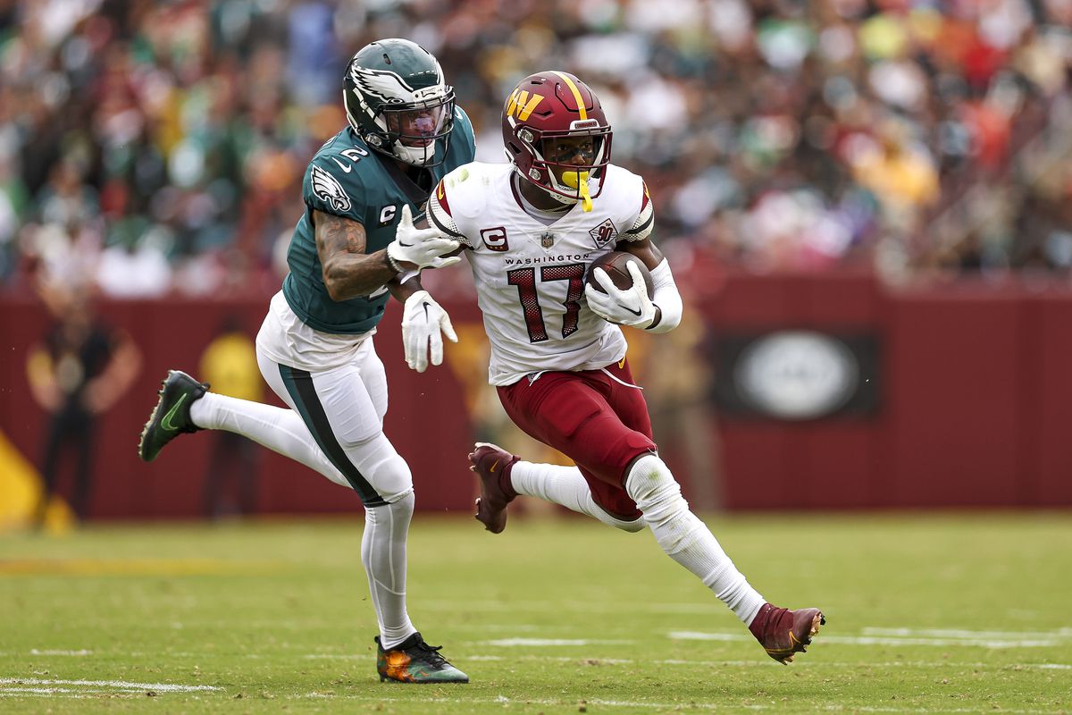 Cornerback Darius Slay of the Philadelphia Eagles tackles wide receiver Terry McLaurin of the Washington Commanders during the second half at FedExField on September 25, 2022 in Landover, Maryland.