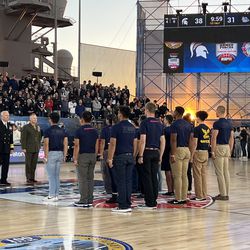 US Navy and Marine recruits take their oath as enlistees at center court during halftime of the Michigan State-Gonzaga game in the Armed Forces Classic, Nov. 11, 2022.