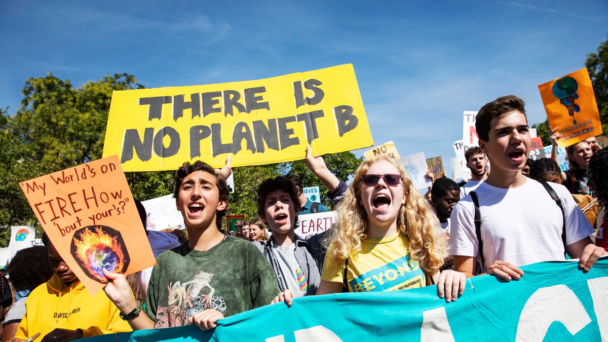 Global Climate Strike protesters march, chant, and hold signs, one of which reads, “There is no planet B.”