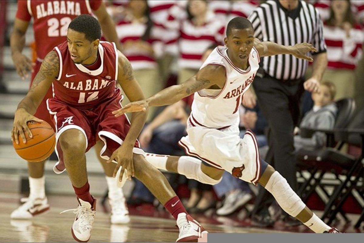 Razorbacks guard BJ Young (11) attempts to steal the ball from Crimson Tide guard Trevor Releford (12) at Bud Walton Arena. Alabama defeated Arkansas 79-68. (Credit: Beth Hall-US PRESSWIRE)