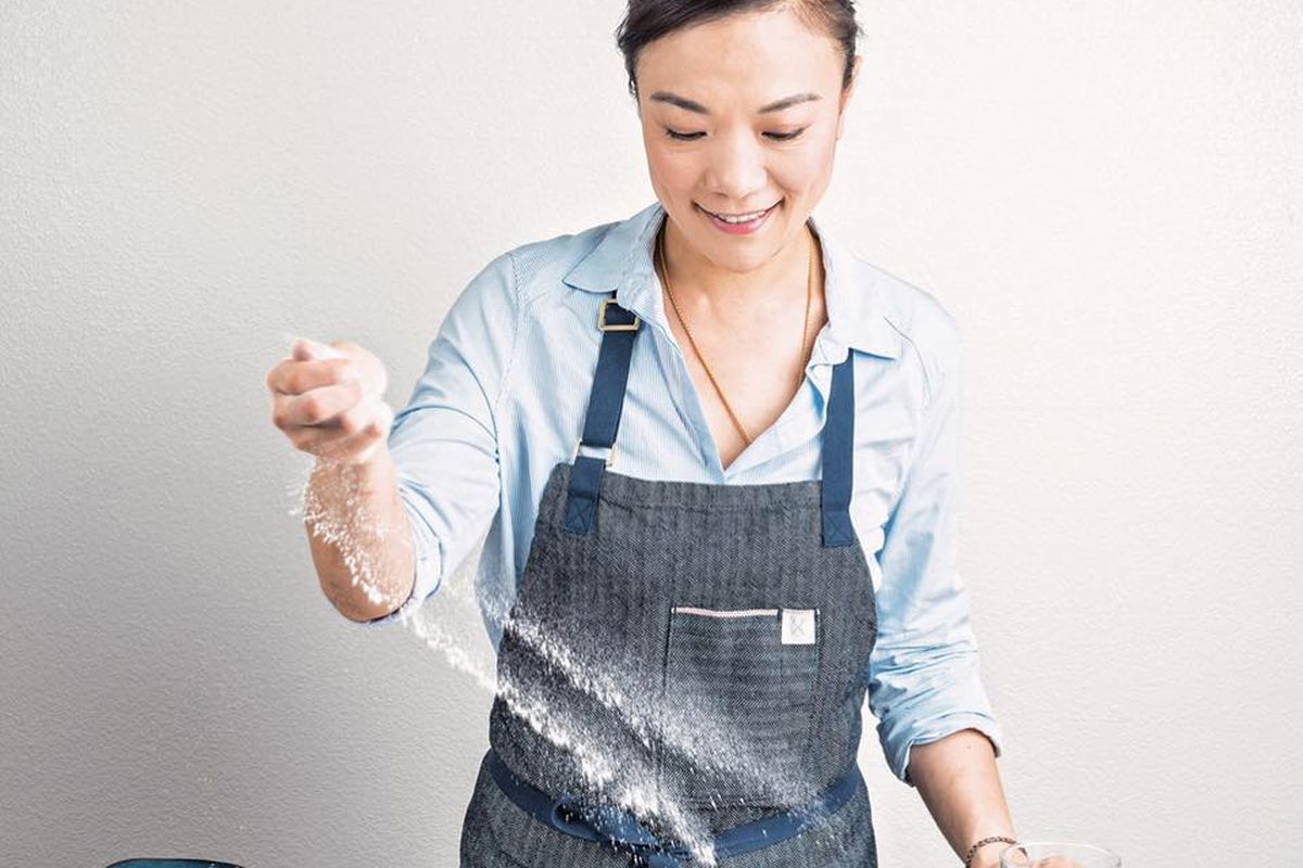 A chef tosses flour on a table