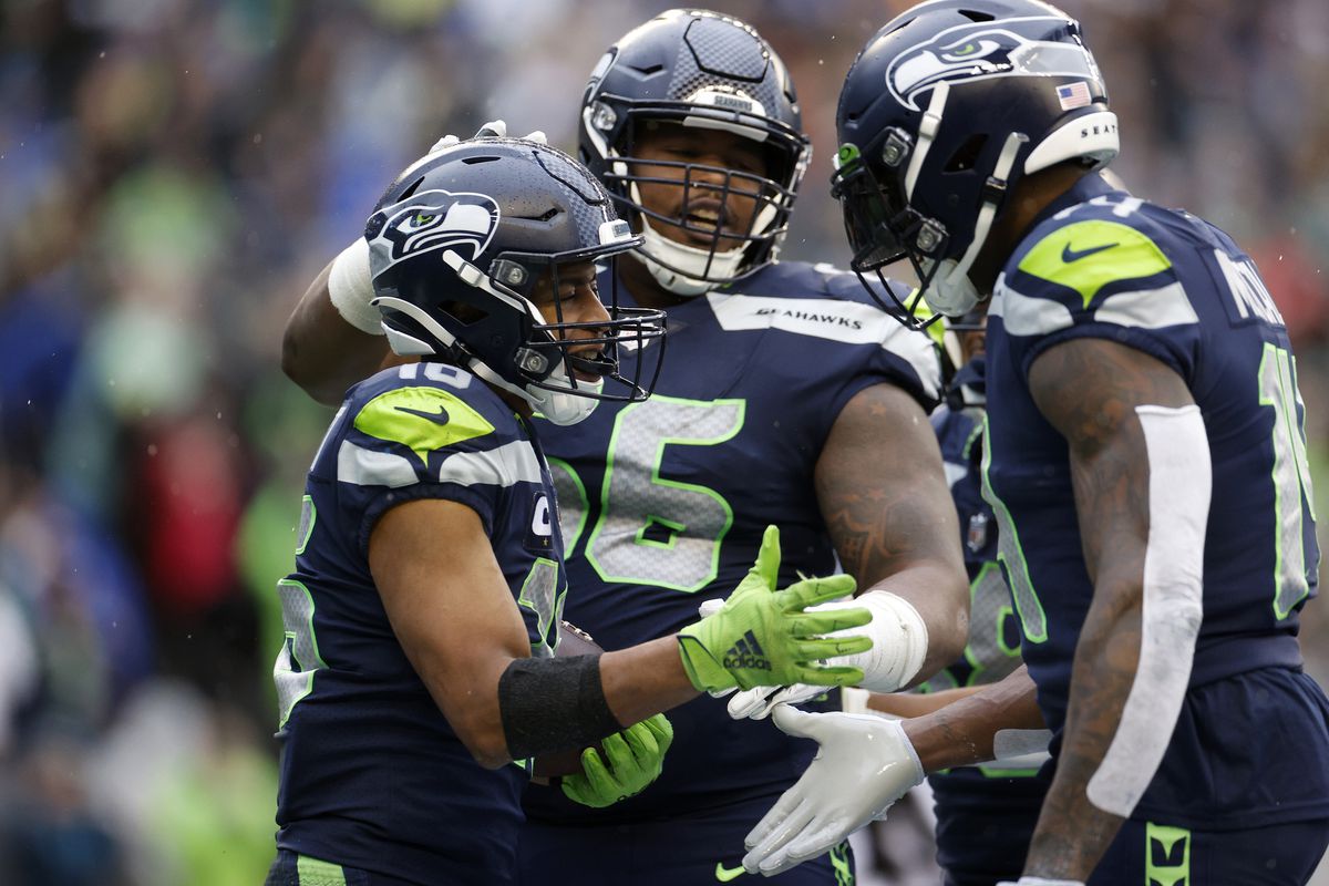 Tyler Lockett #16 and DK Metcalf #14 of the Seattle Seahawks celebrate a touchdown during the third quarter against the Los Angeles Rams at Lumen Field on January 08, 2023 in Seattle, Washington.