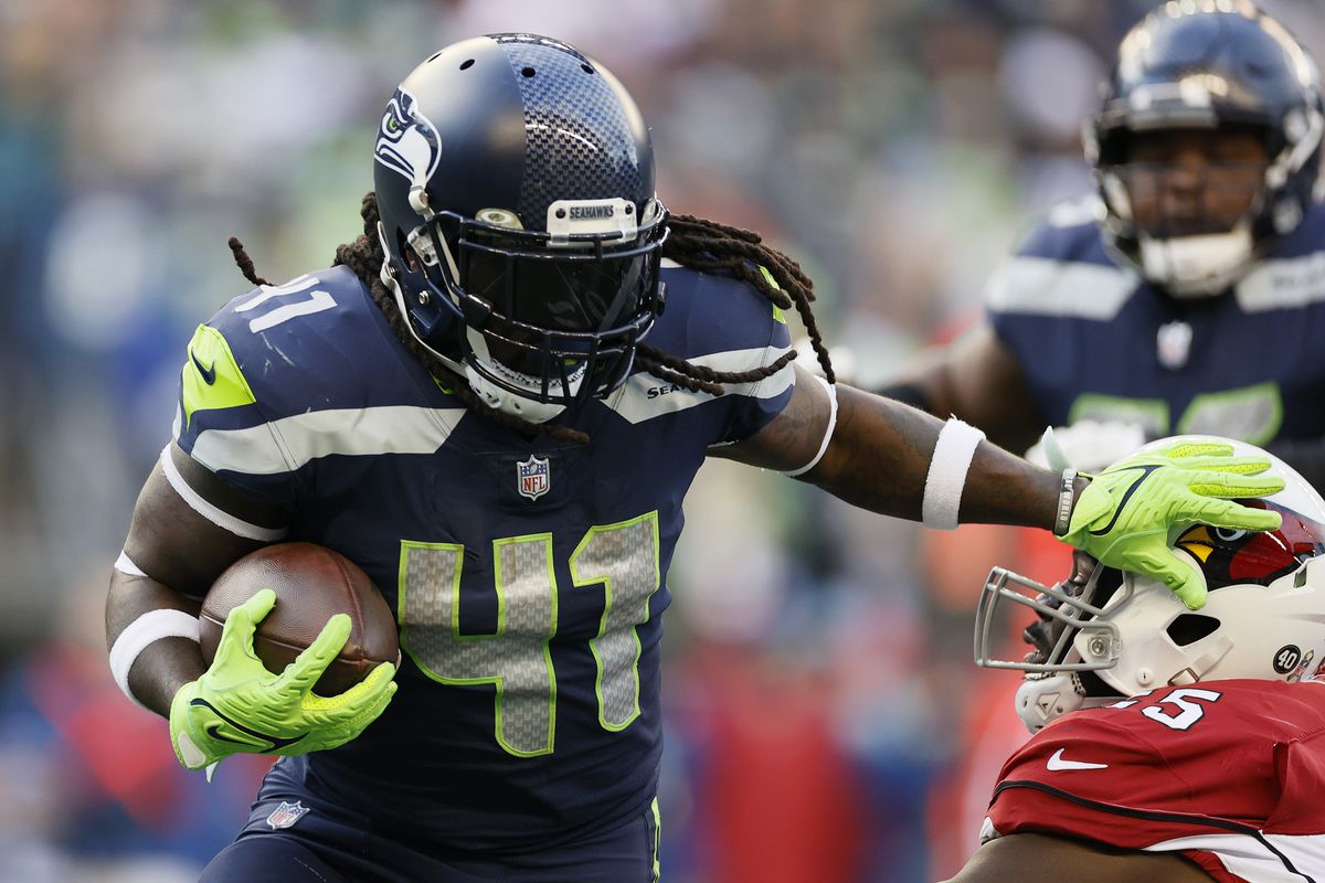 Alex Collins #41 of the Seattle Seahawks avoids a tackle by Chandler Jones #55 of the Arizona Cardinals during the third quarter at Lumen Field on November 21, 2021 in Seattle, Washington.