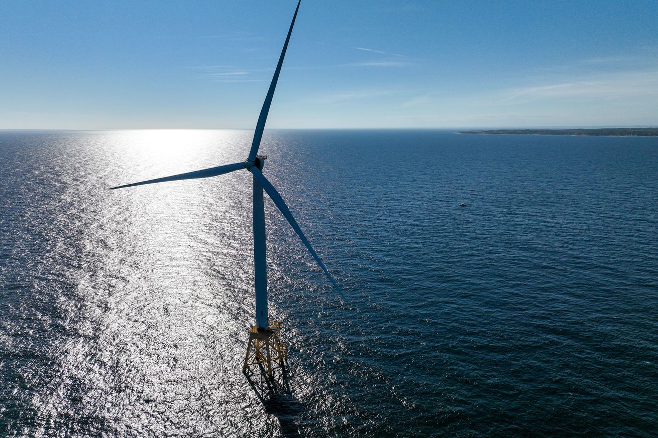 In an aerial view, an offshore wind turbine generates electricity