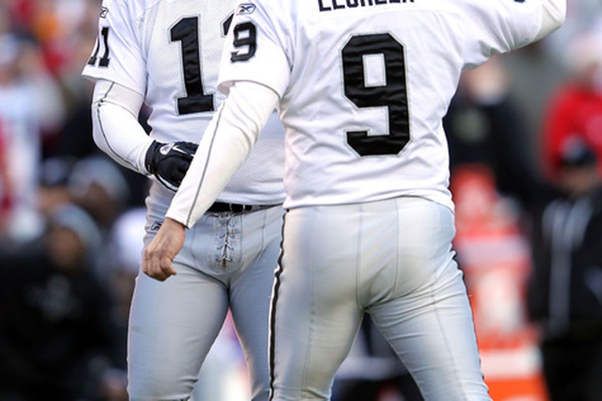 Sebastian Janikowski #11 of the Oakland Raiders is congratulated by Shane Lechler #9 after kicking a game-winning field goal
