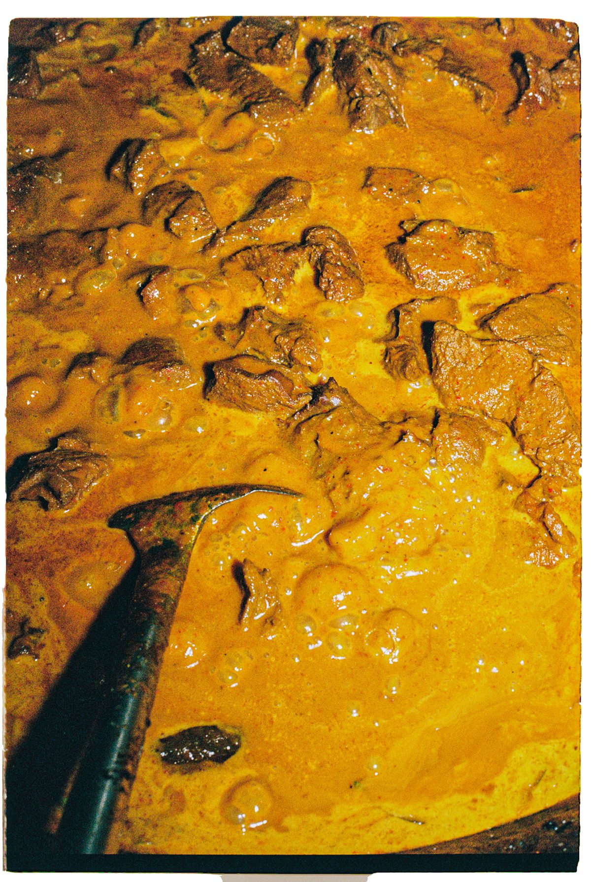 Yellow curry with chunks of beef.