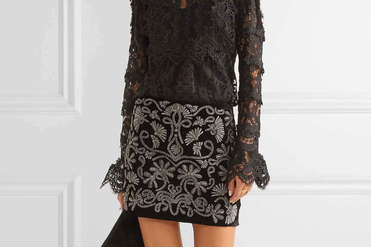 Model in the Alice + Olivia “Elana” skirt, a black velvet skirt with silver embroidery.