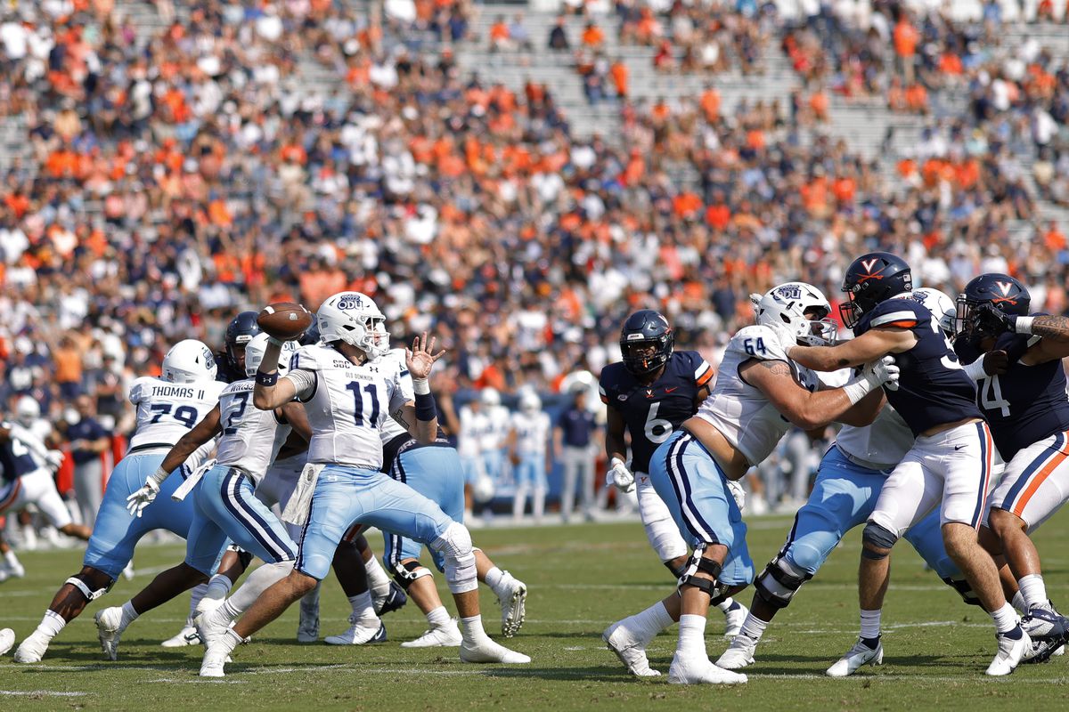 Old Dominion Monarchs quarterback Hayden Wolff passes the ball as Virginia Cavaliers linebacker Nick Jackson chases during the second quarter at Scott Stadium.