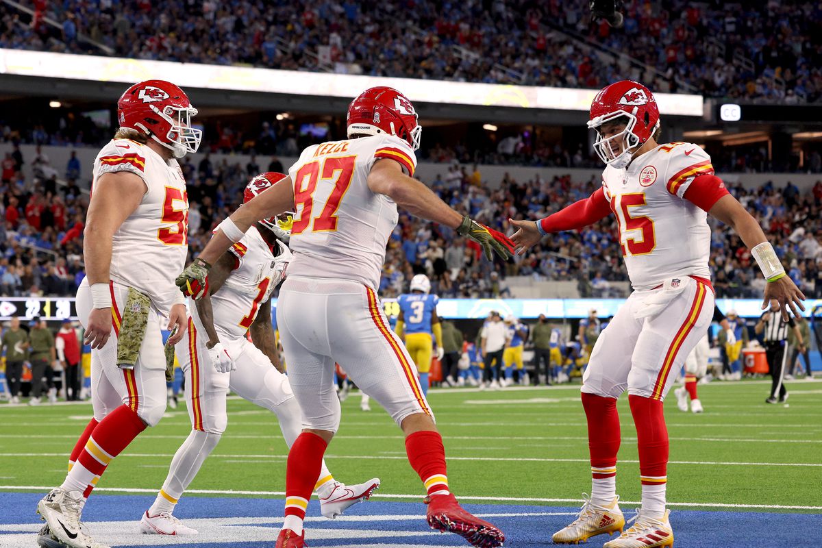Travis Kelce #87 of the Kansas City Chiefs celebrates his touchdown catch with Patrick Mahomes #15 and Creed Humphrey #52, to take a 23-20 lead over the Los Angeles Chargers, during a 30-27 Chiefs win at SoFi Stadium on November 20, 2022 in Inglewood, California.