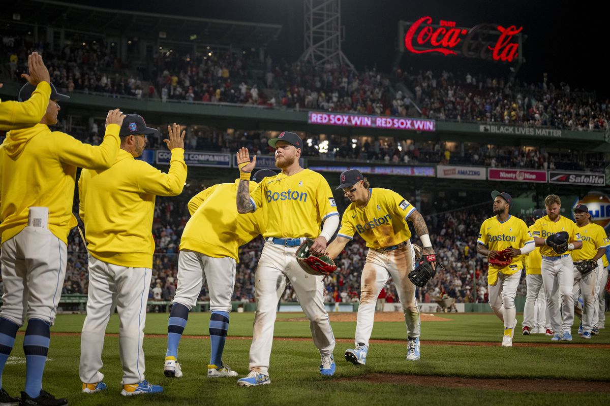 Boston Red Sox high celebrate winning game two of a doubleheader against the New York Yankees on June 18, 2023 at Fenway Park in Boston, Massachusetts.