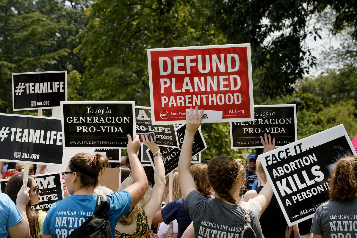  Anti-abortion activists hold a rally opposing federal funding for Planned Parenthood in front of the US Capitol on July 28, 2015, in Washington, DC. 