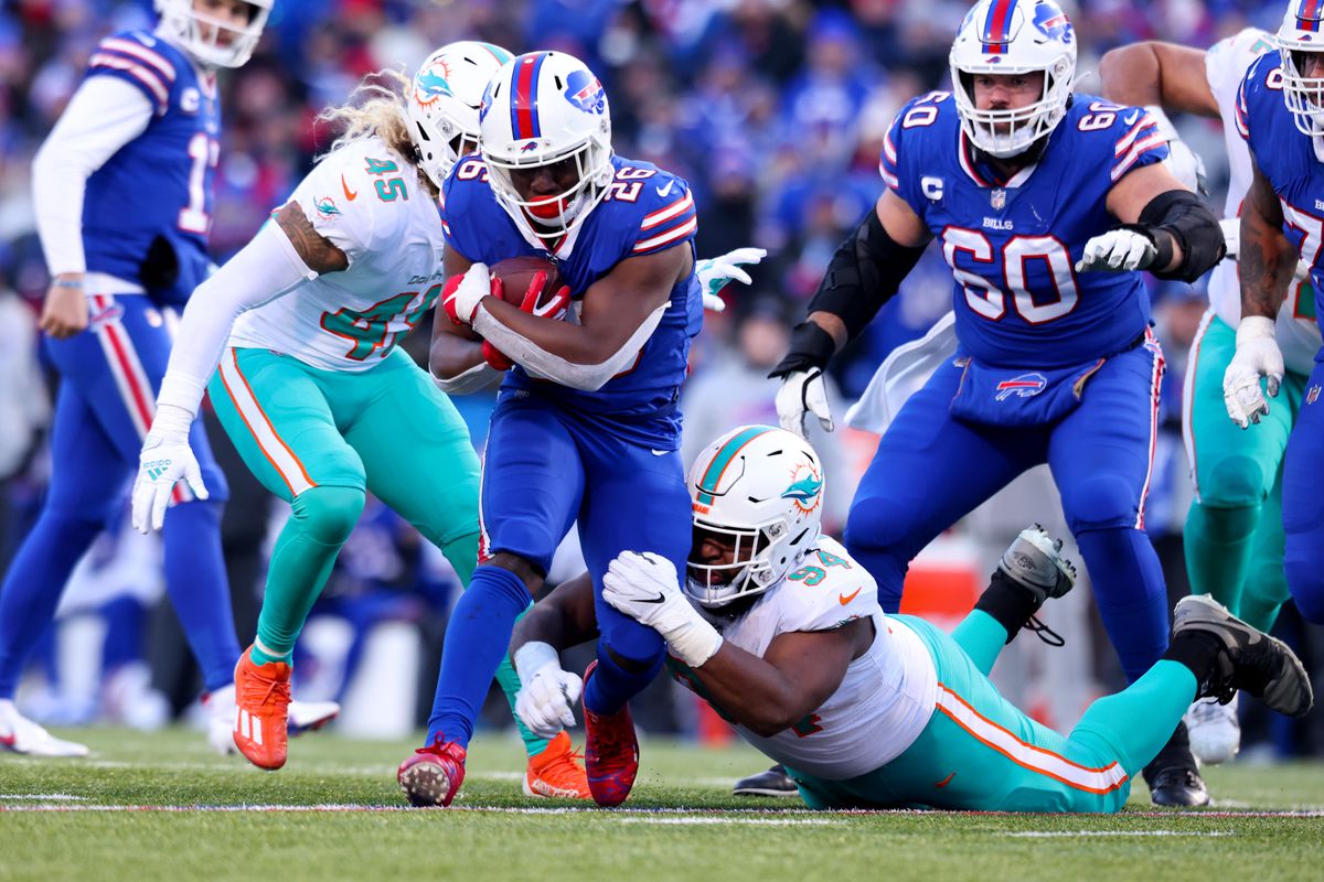 Devin Singletary #26 of the Buffalo Bills carries the ball against the Miami Dolphins during the second half of the game in the AFC Wild Card playoff game at Highmark Stadium on January 15, 2023 in Orchard Park, New York.