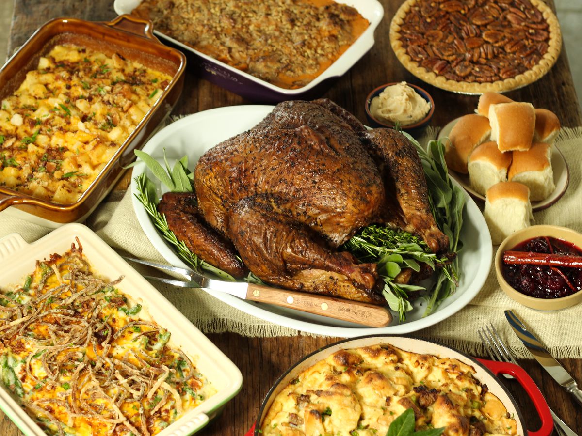 Goode Company BBQ’s Thanksgiving spread with smoked turkey, cranberry sauce, rolls, green bean casserole, stuffing, and more.