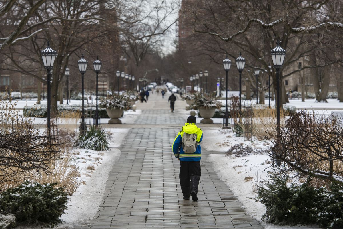 Pedestrians walk through the University of Chicago campus in March 2021.