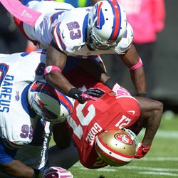 Buffalo Bills cornerback Aaron Williams (23) and defensive tackle Marcell Dareus (99) tackle San Francisco 49ers running back Frank Gore (21) at Candlestick Park. The 49ers defeated the Bills, 45-3.