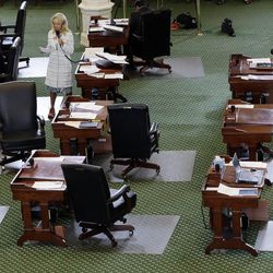 Sen. Wendy Davis, D-Fort Worth, stands on a near empty senate floor as she filibusters in an effort to kill an abortion bill, Tuesday, June 25, 2013, in Austin, Texas. The bill would ban abortion after 20 weeks of pregnancy and force many clinics that perform the procedure to upgrade their facilities and be classified as ambulatory surgical centers.  (AP Photo/Eric Gay)
