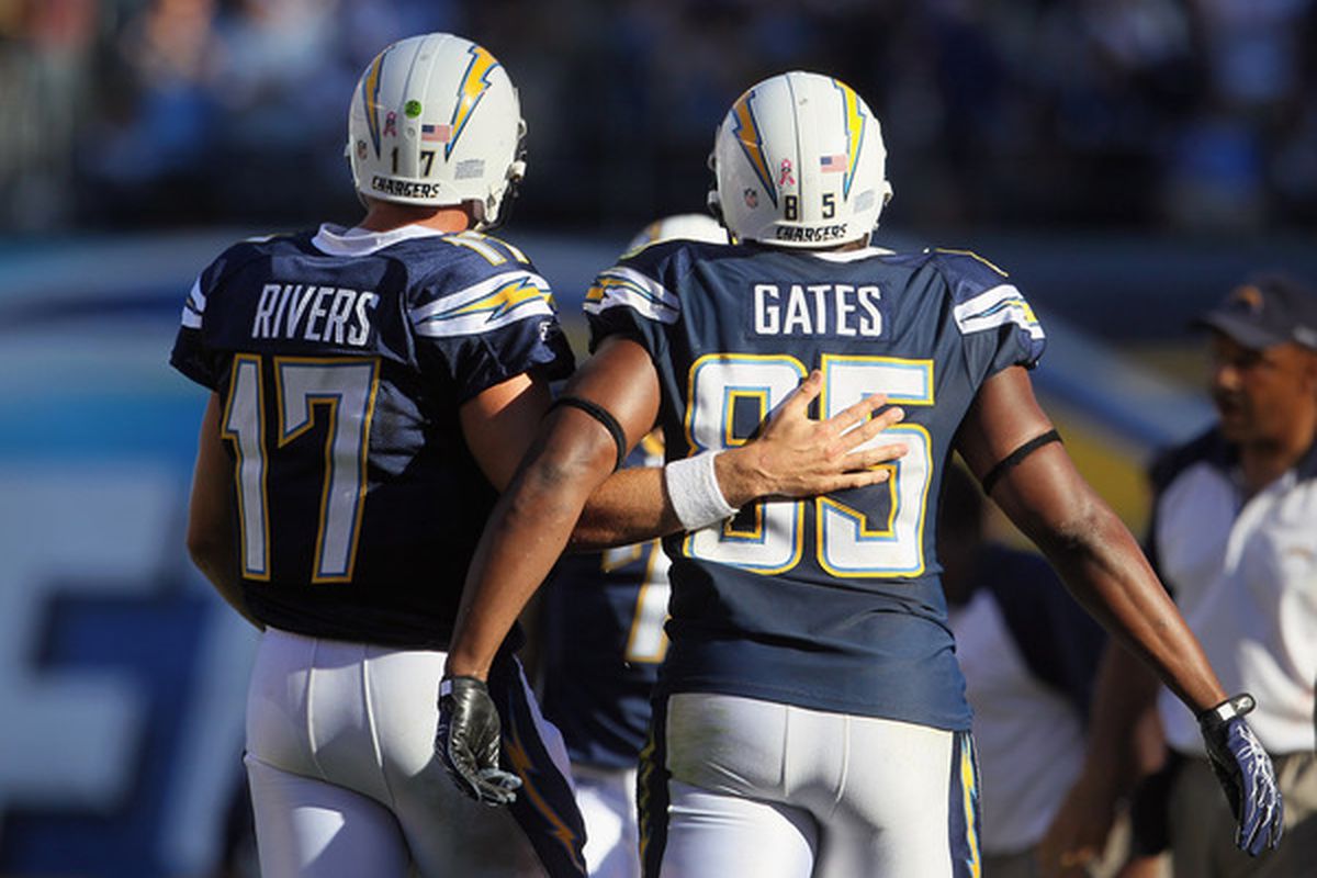 Rivers tries hard not to break his hand on Gates' chiseled shoulder muscles while patting him on the back.  (Photo by Jeff Gross/Getty Images)