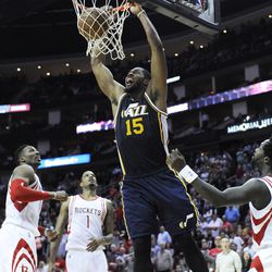 Utah Jazz's Derrick Favors (15) dunks the ball as Houston Rockets Dwight Howard, left, Trevor Ariza (1) and Patrick Beverley look on in the second half of an NBA basketball game Wednesday, March 23, 2016, in Houston. The Jazz won 89-87. (AP Photo/Pat Sullivan)