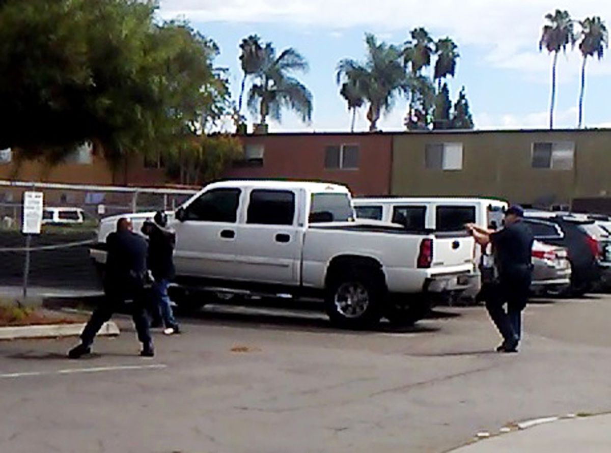 In this frame from a video provided by the El Cajon Police Department, Alfred Olango (second from left) faces police officers in El Cajon, California, on Tuesday, Sept. 27, 2016. He was acting erratically at a strip mall in suburban San Diego and was fata