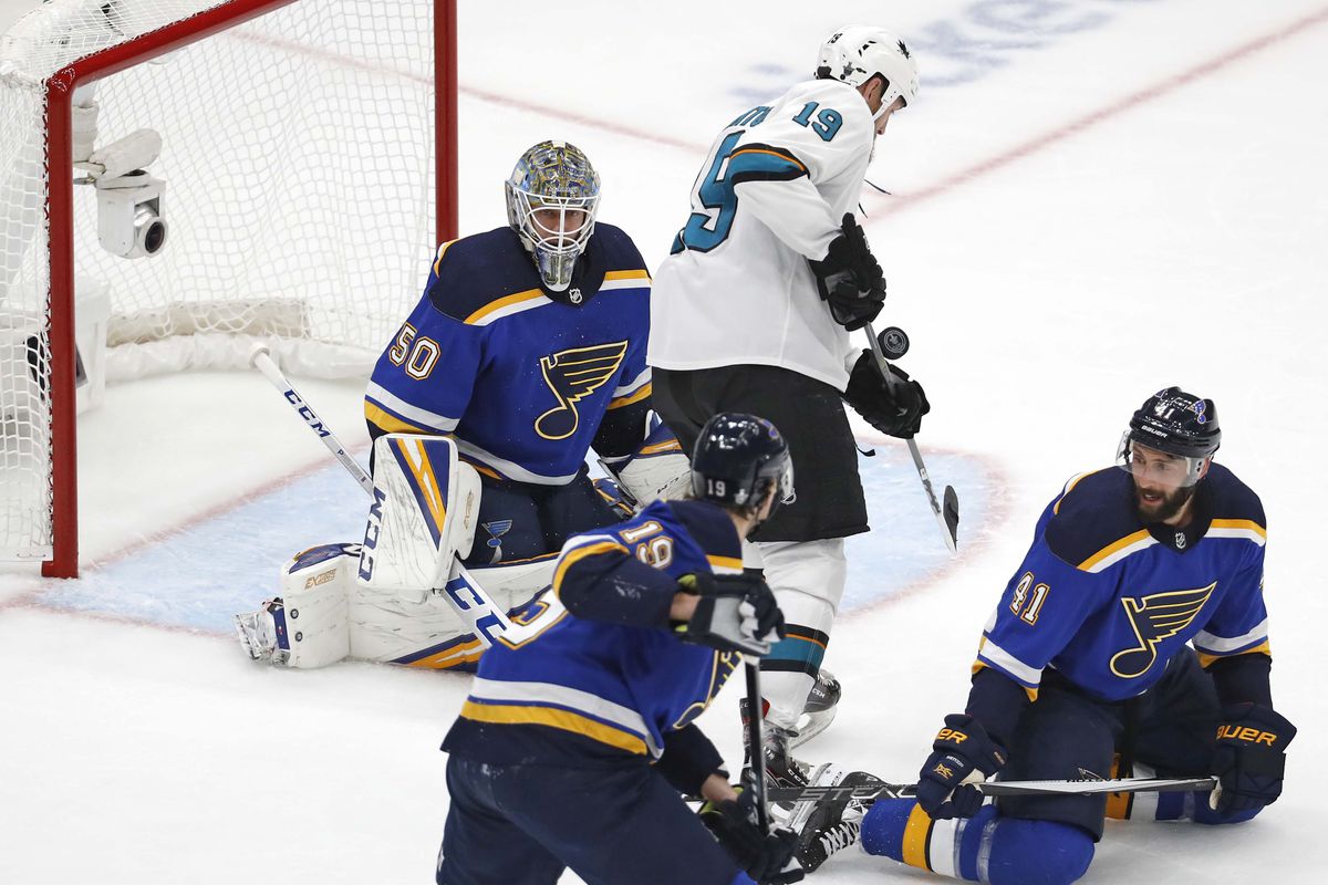 San Jose Sharks center Joe Thornton deflects a shot in front of St. Louis Blues goaltender Jordan Binnington as defenseman Jay Bouwmeester and defenseman Robert Bortuzzo look on during the first period&nbsp;in game 3 of the Western Conference Final of the