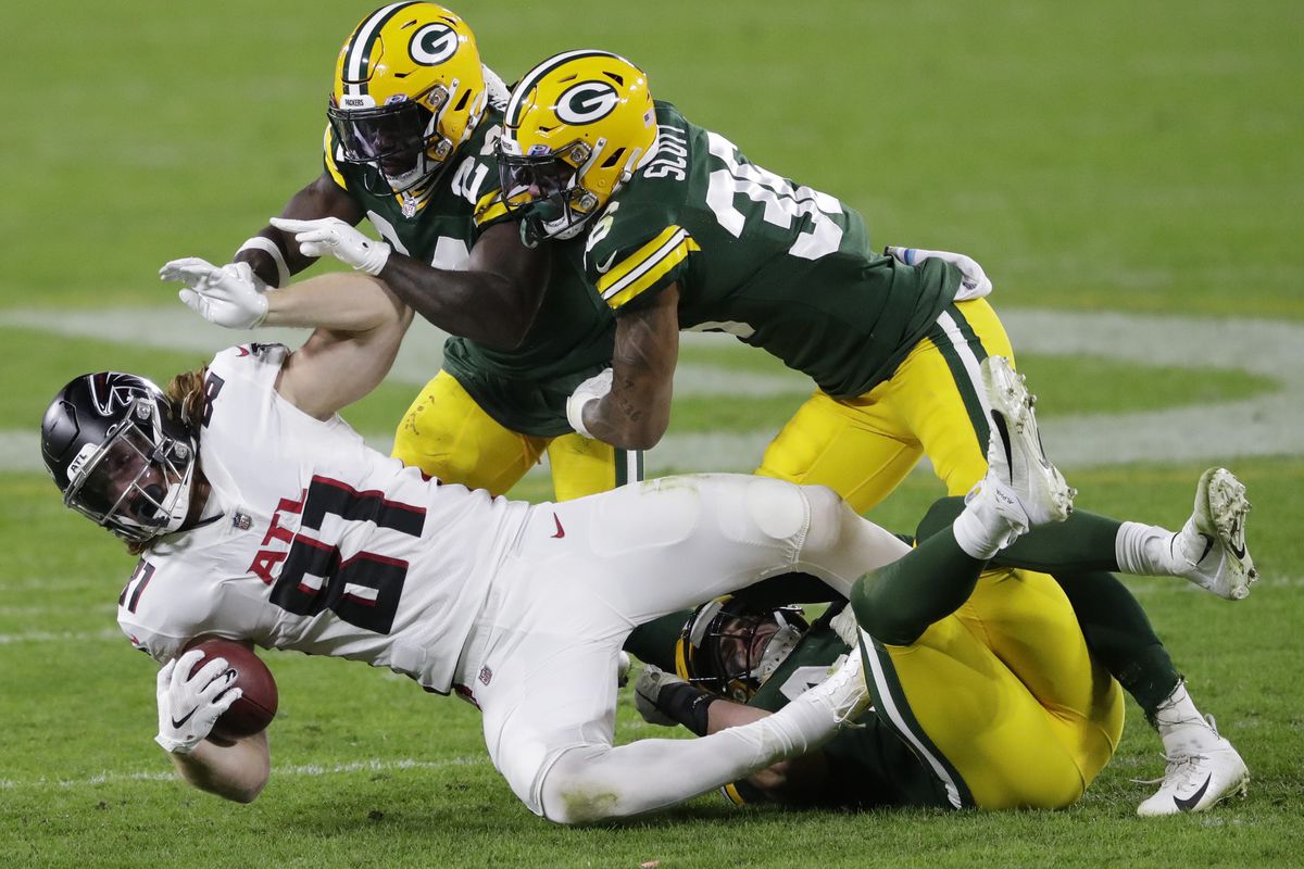 Atlanta Falcons tight end Hayden Hurst (81) is brought down by Green Bay Packers safety Raven Greene (24), Vernon Scott (36) and Ty Summers (44) during their football game Monday, October 5, 2020, at Lambeau Field in Green Bay, Wis.