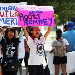 A coalition of activists protests outside the Grand America Hotel as Mitt Romney visits Salt Lake City, Tuesday, Sept. 18, 2012. 