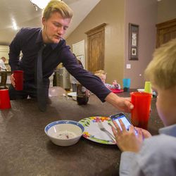 Nathan Honey sets the dinner table Sunday, Nov. 16, 2014, at their home after church. Nathan is an American Fork High football player and helps out with his four brothers who struggle with muscular dystrophy. 