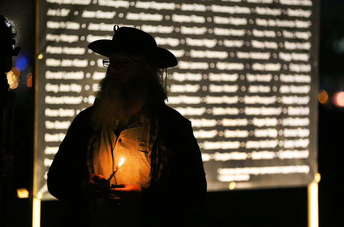 Carl Spitzmacher holds a candle during a candlelight vigil in Salt Lake City on Thursday, Dec 20, 2018 at Pioneer Park to remember the 121 homeless men and women who died during the year.