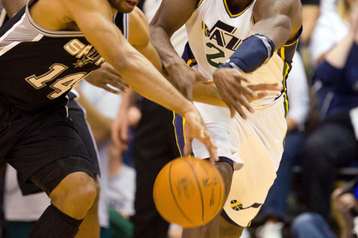 April 9, 2012; Salt Lake City, UT, USA; San Antonio Spurs point guard Gary Neal (14) and Utah Jazz power forward Paul Millsap (24) battle for a loose ball during the first half at Energy Solutions Arena. Mandatory Credit: Russ Isabella-US PRESSWIRE