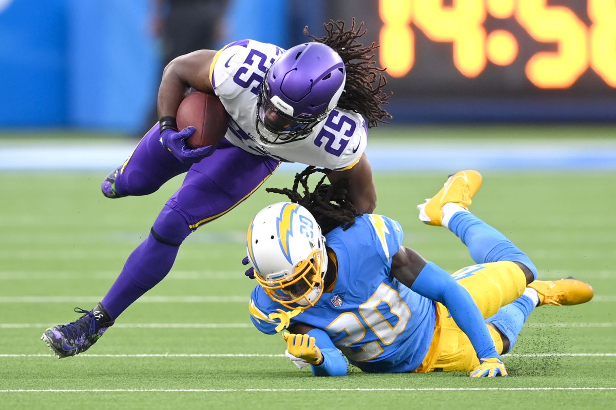 Minnesota Vikings running back Alexander Mattison (25) is forced out of bounds by Los Angeles Chargers defensive back Tevaughn Campbell (20) after a first down in the second half at SoFi Stadium.