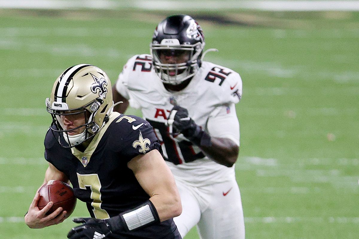 Taysom Hill #7 of the New Orleans Saints carries the ball as Charles Harris #92 of the Atlanta Falcons defends in the fourth quarter at Mercedes-Benz Superdome on November 22, 2020 in New Orleans, Louisiana.