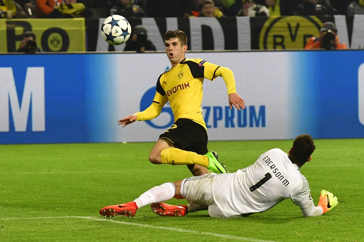 Dortmund's US midfielder Christian Pulisic scores the 2-0 goal past Benfica's Brazilian goalkeeper Ederson Moraes during the UEFA Champions League Round of 16, 2nd-leg football match Borussia Dortmund v SL Benfica in Dortmund, western Germany on March 8, 2017. / AFP PHOTO / John MACDOUGALL (Photo credit should read JOHN MACDOUGALL/AFP/Getty Images)
