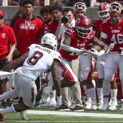 Utah Utes wide receiver Bryan Thompson (19) tries to avoid Northern Illinois Huskies safety Mykelti Williams (8) during first-half action in the University of Utah versus Northern Illinois football game at Rice-Eccles Stadium in Salt Lake City on Saturday, Sept. 7, 2019.
